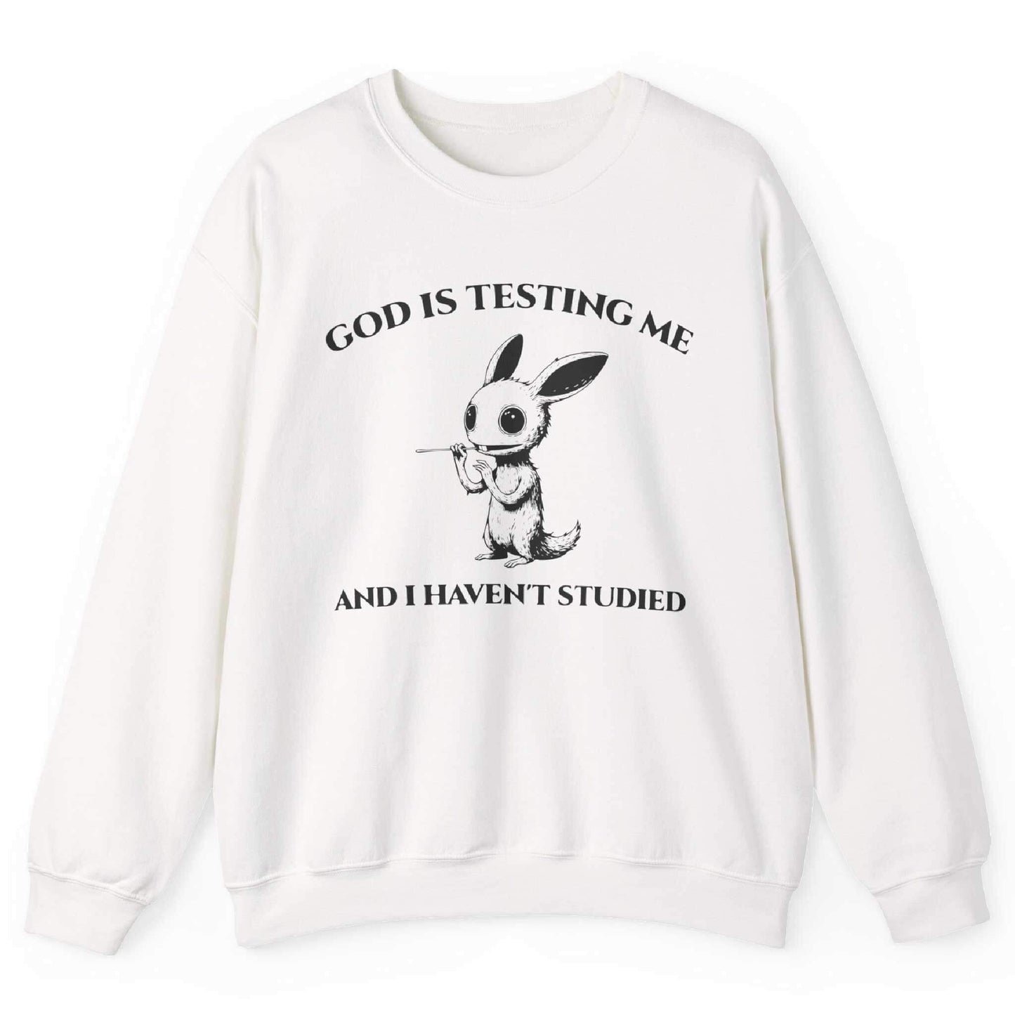 White sweatshirt with quirky creature graphic and “God Is Testing Me And I Haven’t Studied” text – front view, by Shirtcasm