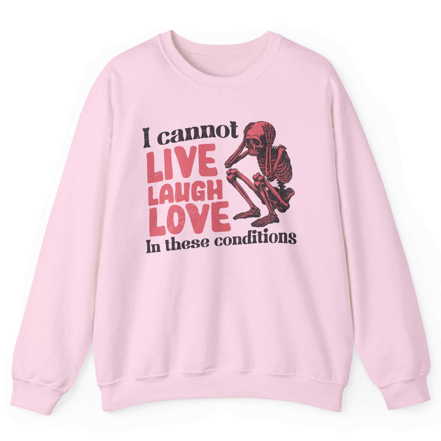 Light pink sweatshirt with distressed skeleton graphic and “I Cannot Live Laugh Love In These Conditions” text – front view, by Shirtcasm