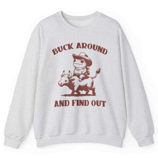 Ash sweatshirt with cowboy frog riding bull and “Buck Around and Find Out” text – front view, by Shirtcasm
