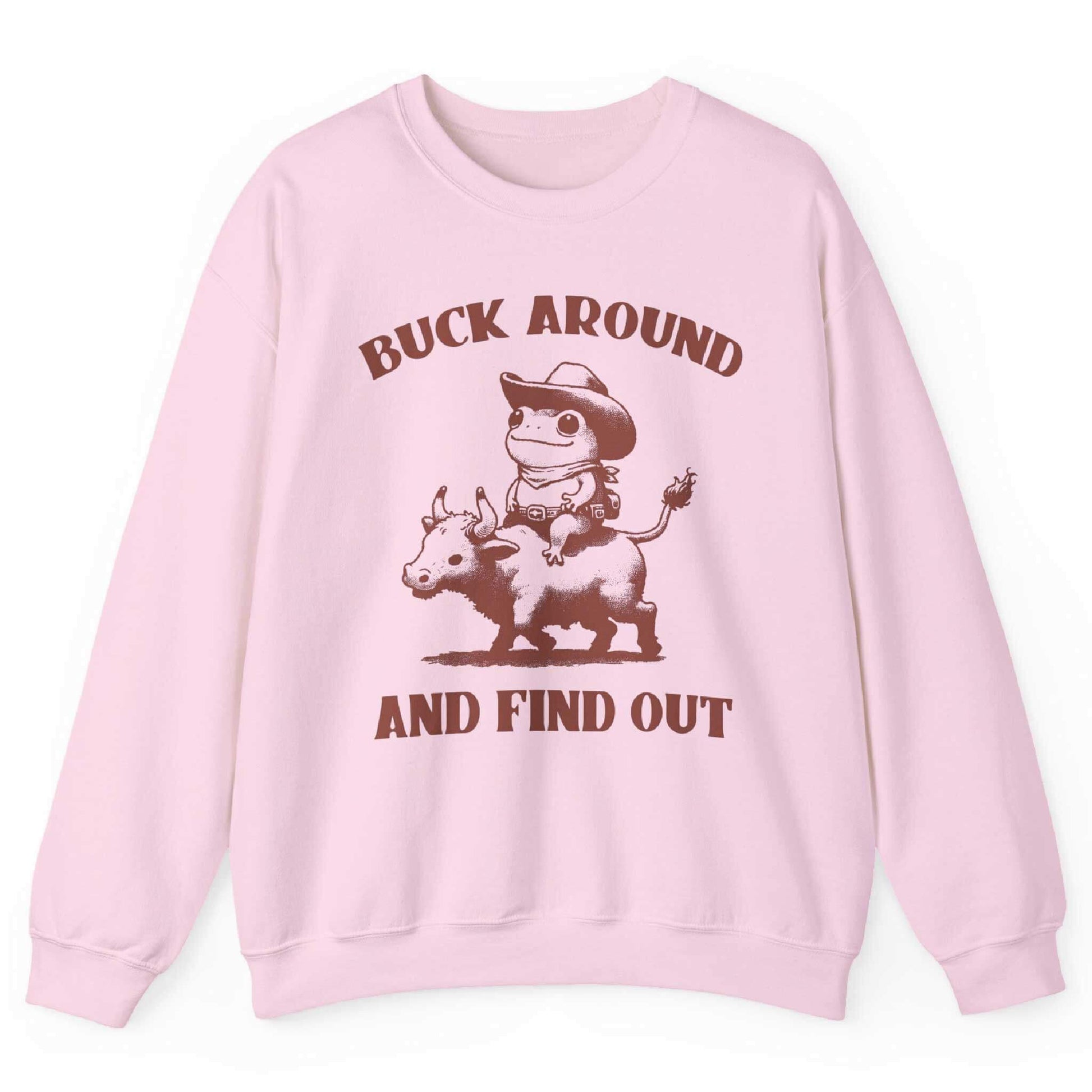 Light pink sweatshirt with cowboy frog riding bull and “Buck Around and Find Out” text – front view, by Shirtcasm