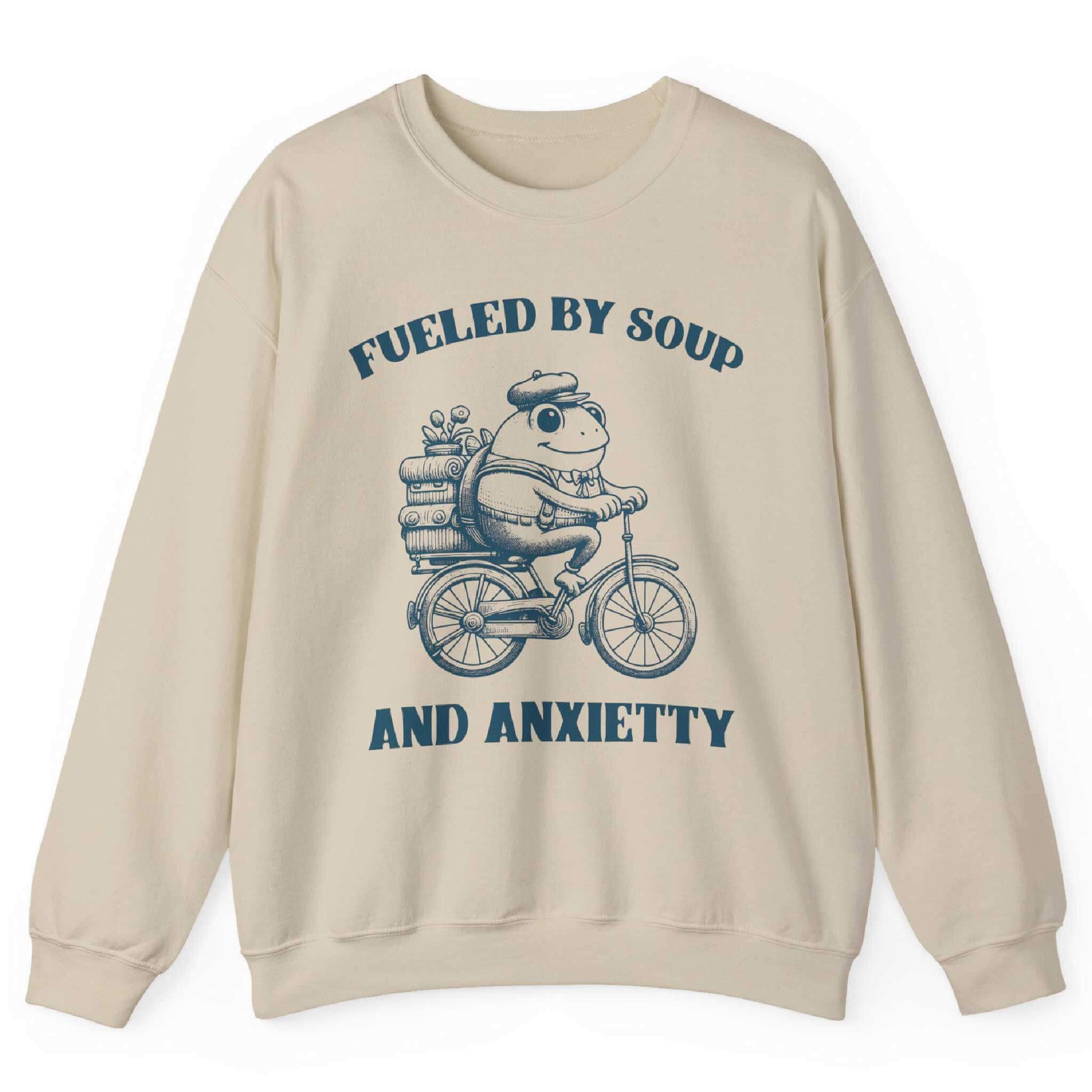 Sand sweatshirt with frog riding bicycle carrying soup cans and “Fueled by Soup and Anxiety” text – front view, by Shirtcasm