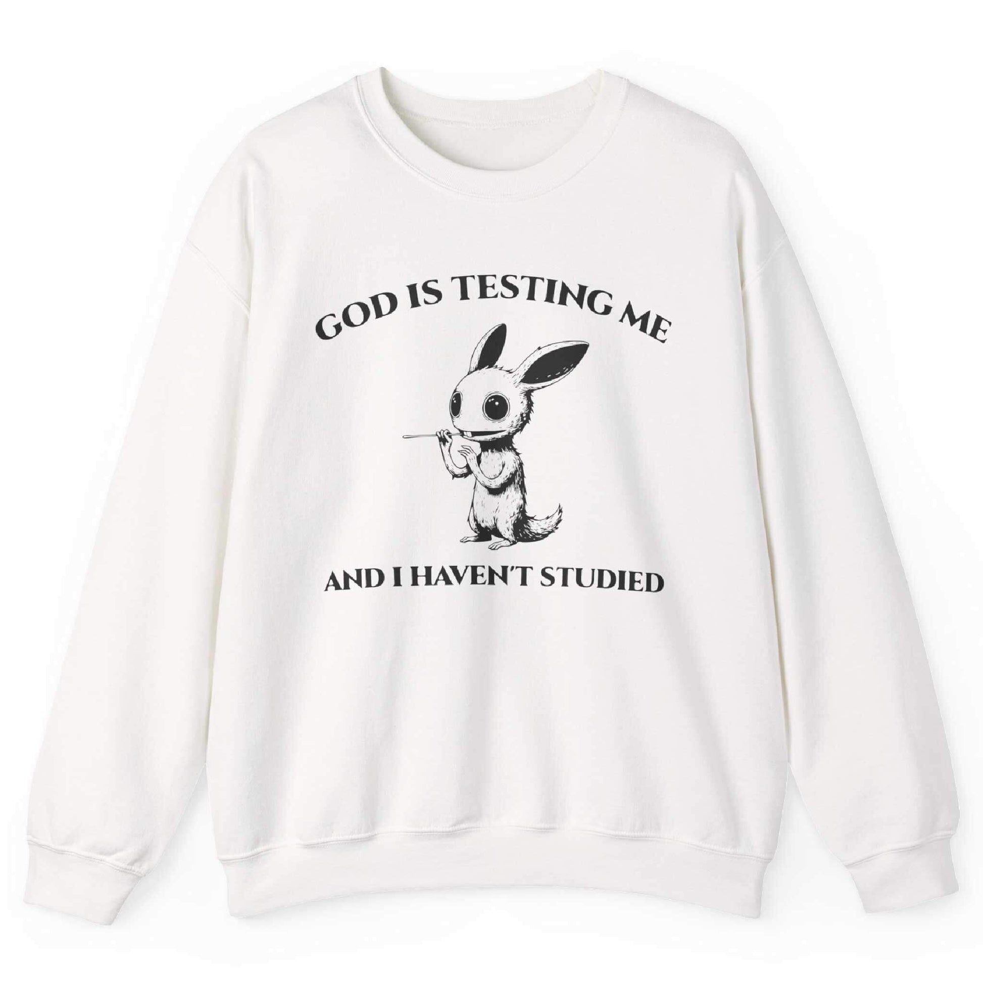 White sweatshirt with quirky creature graphic and “God Is Testing Me And I Haven’t Studied” text – front view, by Shirtcasm
