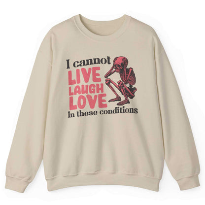 White sweatshirt with distressed skeleton graphic and “I Cannot Live Laugh Love In These Conditions” text – front view, by Shirtcasm