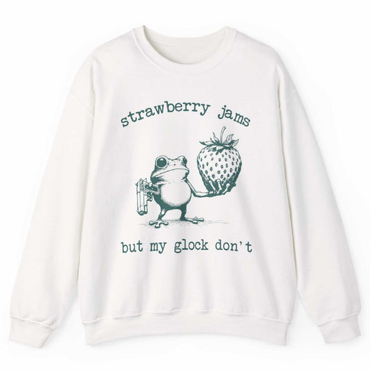 White sweatshirt with frog holding strawberry and “Strawberry Jams But My Glock Don’t” text – front view, by Shirtcasm